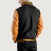 Men’s black varsity letterman jacket with wool body and gold leather sleeves back view
